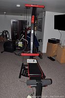Front view of Bowflex PR1000 home gym machine showing bench, pulleys, and resistance rods.