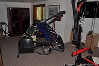 Wide view of the elliptical trainer in a room, showing the full frame and attached computer console.