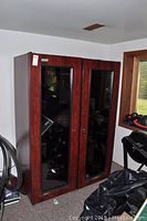 Front view of double door wine fridge with wood-grain exterior and tinted glass panels