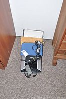 Canon CanoScan 8800F scanner and Acer Aspire R11 laptop stacked with power adapters on carpeted floor