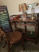 Desk with lamps, paperweight, bowl, and throw on or under it
