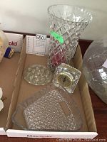 Full view of the glass vase, glass clock, glass tray, and glass frog figurine grouped together in a box.