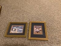 Two framed prints of children playing at the seaside with dark matte and gold frames