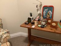 Golf themed decor collection on wooden table showing statues, mug, bookends and small items