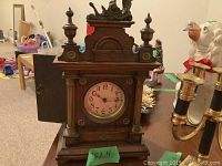 Wooden mantle alarm clock front with open door showing clock face and wood craftsmanship