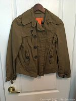 Front view of olive green women's coat on hanger.