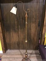 Full view of the antique bronze-colored floor lamp showing height and overall design