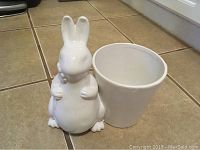 White ceramic bunny planter with separate round white ceramic pot beside it.