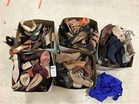 Four boxes filled with size 9 women's footwear in used condition, showing different colors and styles including boots and heels.