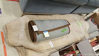 Calvin Klein indoor/outdoor runner rug showing backing and rolled shape on beige shag rug