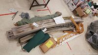 Full contents: bentwood frame components, rope hammock cords, canvas hammock bag, hanging chain, hardware box, green cushions