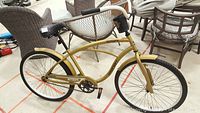 Full side view of the gold-colored Dynacraft Nantucket adult road bike showing frame, tires, pedals, and handlebar.
