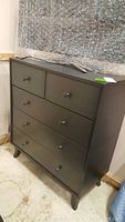 Front view of the modern five drawer dresser, showing two smaller top drawers and three larger bottom drawers with round knobs.