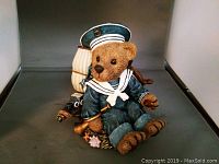 Front view of the sailor teddy bear sitting on the ship music box