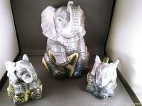 Three-piece ceramic elephant set with large cookie jar, cream, and sugar bowl.