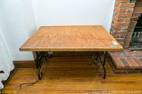 Top view of wooden rectangular table top showing wear and marks