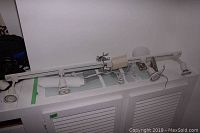 48 inch white track lighting fixture with four spotlights shown from top-down view on white surface