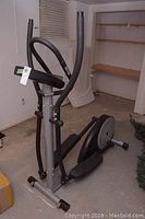 Full view of the Infiniti computerized elliptical machine showing overall machine and handlebars.