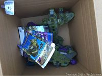 Green Pelican dropship vehicle in a cardboard box with folded instruction sheets.