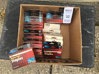 Overhead photo showing a cardboard box containing multiple packs of staples, including 25 packs visible.