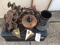 Overview photo showing all items together on a black surface outdoors.