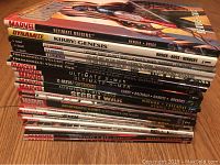 Stack of 23 comic graphic novels showing spine titles including Marvel and Dynamite titles.