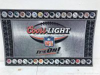 Full view of large rectangular metal sign with Coors Light and NFL logos, football helmet team icons around the border.