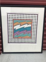 Full view of framed pop art print with geometric patterns in black, teal, purple, and rust tones; black frame with white mat.