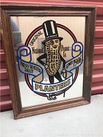 Framed rectangular mirror with Mr. Peanut character and Planters branding graphic.