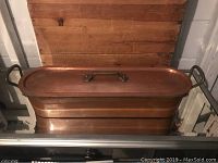 Full view of the copper fish poacher with lid on, showing shape and color.