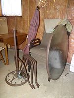 Patio furniture components including table frame, umbrella stand, and umbrella fabric closed up