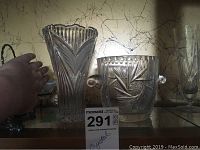 Photo showing pinwheel crystal wine cooler with handles and crystal vase alongside handwritten MaxSold auction sign.
