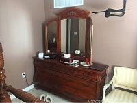 Full view of dresser with mirror attached, showing the entire dresser and three-panel mirror.