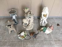 Photo of 8 lawn ornaments including child statues, garden gnome, bird figurines, stone lantern and solar lamp stand.