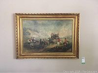 Full view of the large framed print showing a horse-drawn carriage scene in an ornate gold-colored frame