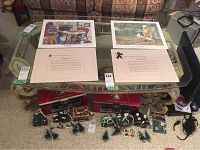 Full view of the coffee table with glass top and decorative frame, showing scale by surrounding items and some scratches on the glass