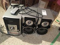 Full view showing Sony Hi-Fi system with remote and speakers on carpeted floor.