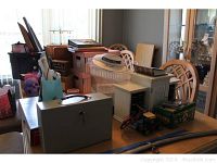 Photo showing CanonScan scanner, metal lock box on table with some boxes and a small vintage truck figurine