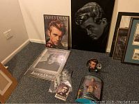 Photo showing all memorabilia items including velvet painting, framed prints, doll in box, stamps, and collectors plate