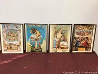 Full set of four framed vintage brewing company prints displayed side by side against a wall.