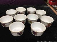 Ten Royal Worcester Evesham porcelain ramekins arranged showcasing fruit designs and gold rims.