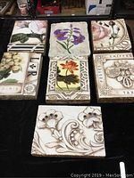 Overhead view of six colored floral Sid Dickens wall tiles