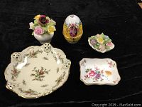 Collection of five vintage bone china items on black background, showing all pieces together