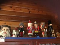 Shelf view showing carved Santa planter, mini pitcher, piano smoker and six nutcrackers