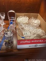 Assorted clear cut glass dishes in box: three scalloped and round bowls plus footed compote