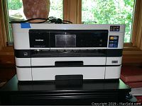 Front view of the Brother Business Smart MFC-J4710DW printer showing overall condition, presence of power cord, and label stickers indicating ink cartridge models.