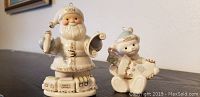 Photo of Lenox 2004 Santa and Teddy Bear figurines from front angle on table.