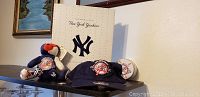 Photo showing New York Yankees 100th Anniversary navy blue hat with logo patch, teddy bear in Yankees outfit, and a white item partially visible behind hat