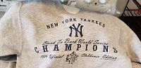 Close-up of front detailing print on gray New York Yankees sweatshirt.