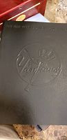 Black leather-like embossed hardcover of New York Yankees 2005 official yearbook showing logo with baseball bat and top hat.